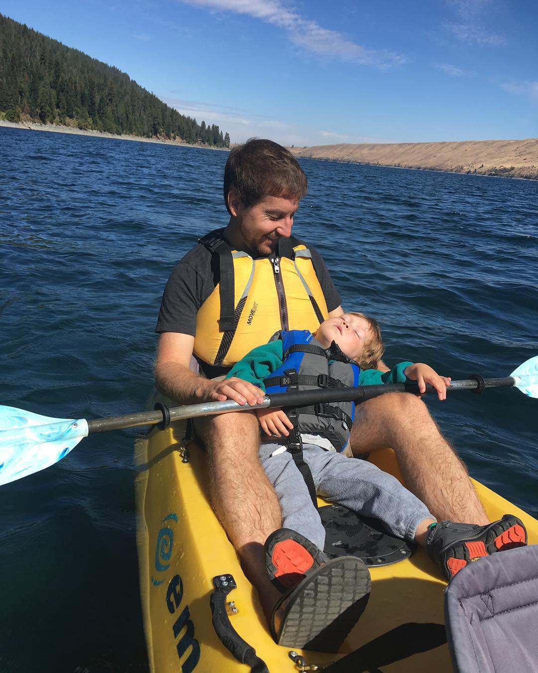 Charlie sleeping in Daniel’s arms in the kayak.
