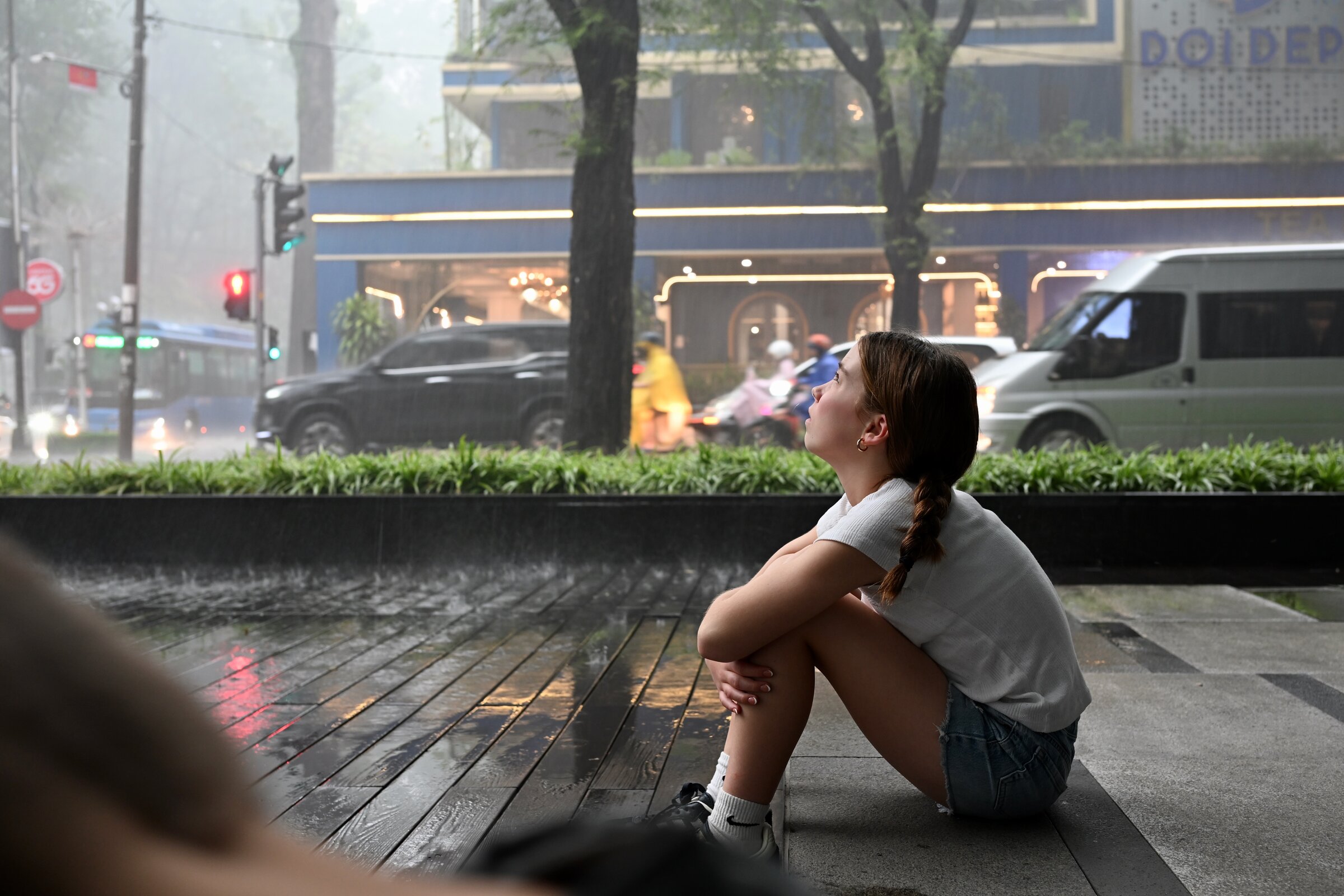 Ava sitting under cover and waiting for the rain to stop